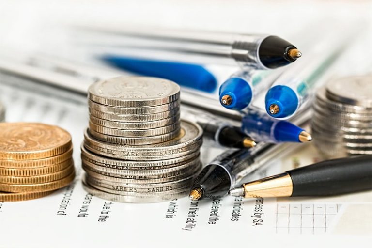 stacked coins and pens