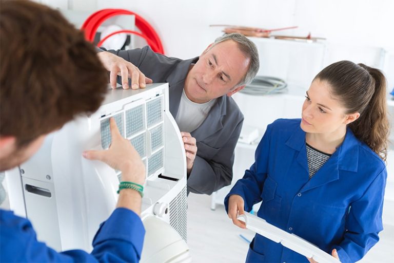student learns air conditioning repair from an experienced instructor