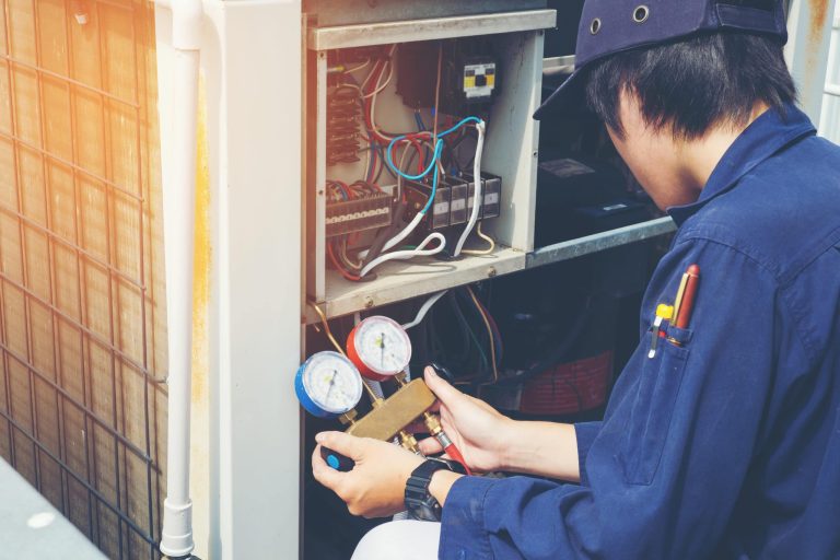 Technician checking air conditioner
